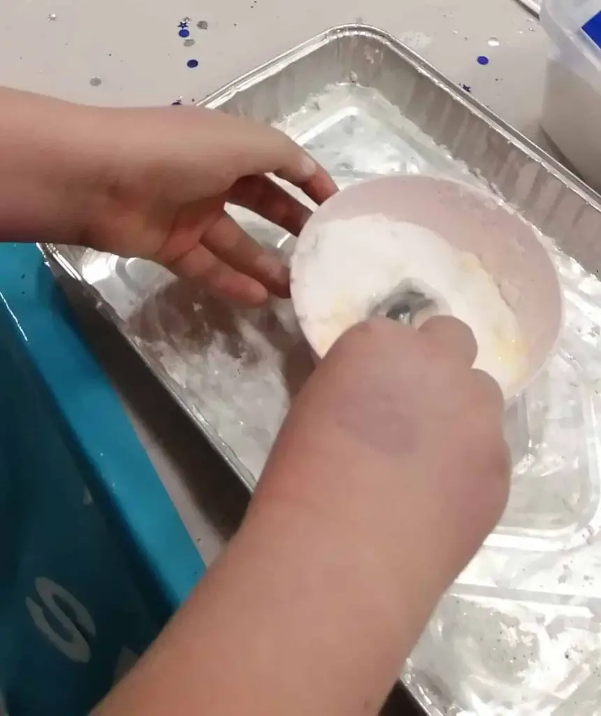 Mixing fake snow in a bowl